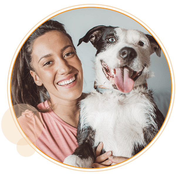 woman smiling with black and white dog